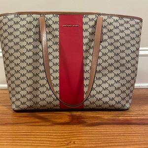 MK logo print purse with thick red stripe.